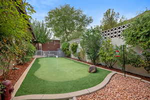 Surrounding community featuring a fenced backyard, an area to practice putting, and a patio area
