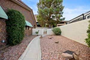 Fenced backyard featuring a gate