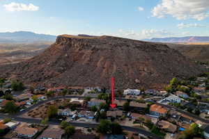 Aerial view of property's location with nearby suburban area and a mountain backdrop