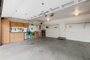 Garage with electric panel and a garage door opener