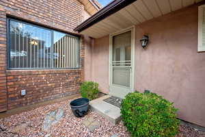 Property entrance with stucco siding