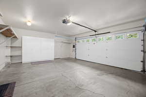 Garage featuring a garage door opener