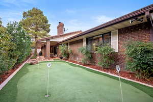 Surrounding community featuring a putting green and a patio