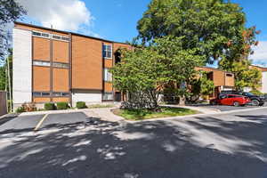 View of building exterior with uncovered parking