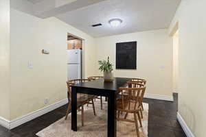 Dining space with a textured ceiling and a textured wall