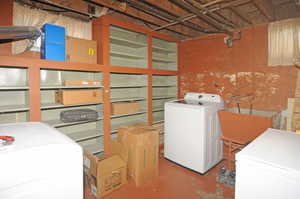 Unfinished basement with washer and dryer and a sink