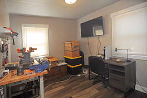 Office area featuring dark wood-style flooring
