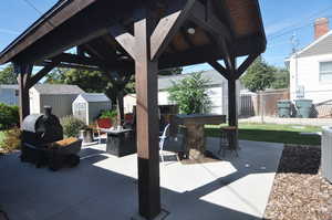 View of patio / terrace with a shed, a gazebo, and a grill