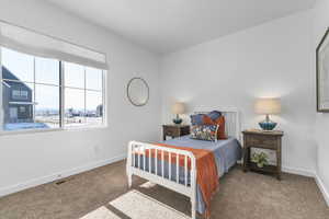 Carpeted bedroom featuring baseboards