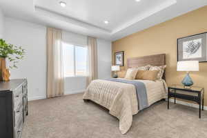 Bedroom featuring a tray ceiling, light colored carpet, and recessed lighting