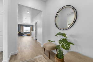 Hallway featuring light wood-style floors and recessed lighting