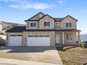 Craftsman inspired home with concrete driveway, a mountain view, a porch, a garage, and brick siding