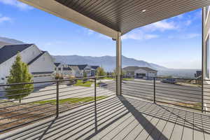 Balcony featuring a mountain view, a residential view, and a sunroom