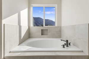 Bathroom featuring a mountain view and a garden tub
