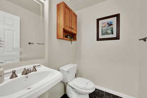 Bathroom featuring a sink and baseboards