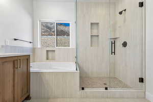 Full bathroom with vanity, a bath, and a shower stall