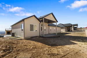 Rear view of house with a patio area and stucco siding