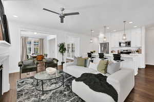 Living room featuring dark wood-type flooring, recessed lighting, a fireplace, and ceiling fan