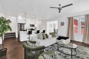 Living room with dark wood-style floors, stairway, recessed lighting, and a ceiling fan