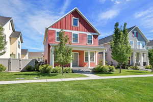 View of front of property featuring board and batten siding, a gate, and covered porch