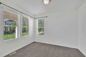 Carpeted empty room featuring baseboards