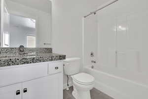 Bathroom featuring bathing tub / shower combination, vanity, and light tile patterned floors