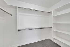 Walk in closet with dark carpet