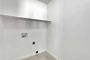 Washroom featuring washer hookup and hookup for an electric dryer