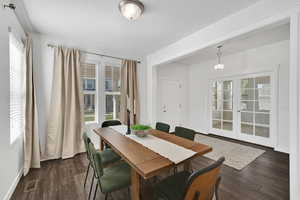 Dining room featuring french doors and dark wood-style flooring