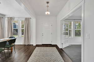 Entrance foyer with baseboards and dark wood finished floors