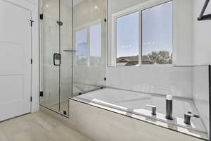 Bathroom featuring a bath and a stall shower