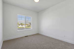 Unfurnished room with carpet flooring and a mountain view