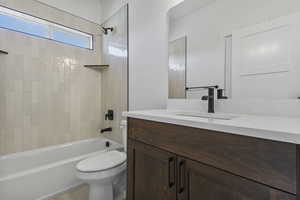 Bathroom featuring vanity and washtub / shower combination