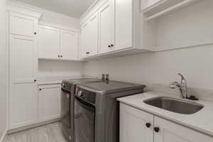 Laundry area with washing machine and clothes dryer and cabinet space