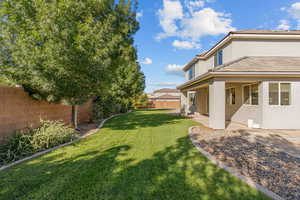 Fenced backyard with a patio area
