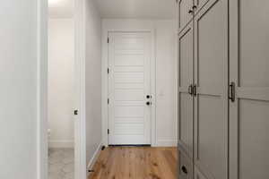 Entryway with wood-type flooring and baseboards