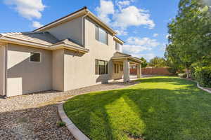 Rear view of house featuring a patio, a fenced backyard, stucco siding, and a tiled roof