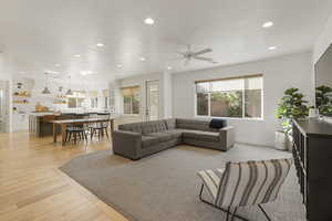 Living area with recessed lighting, light wood-type flooring, and a ceiling fan