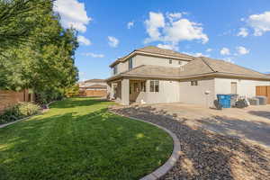 Back of property featuring stucco siding, a fenced backyard, and a tile roof