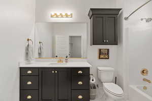 Bathroom featuring vanity, bathing tub / shower combination, and marble finish floors