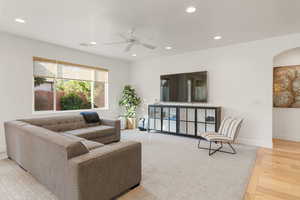 Living area with recessed lighting, light wood-type flooring, and ceiling fan