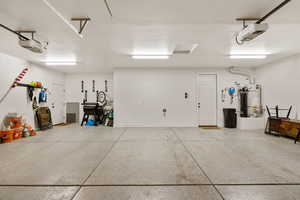 Garage with water heater and a garage door opener