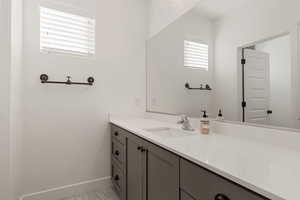 Bathroom with vanity and baseboards