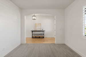 Unfurnished room featuring carpet floors and arched walkways