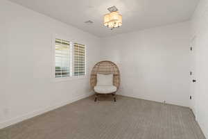 Living area with carpet floors and wood walls