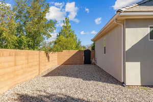 Fenced backyard featuring a gate