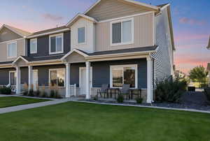 View of front facade featuring a porch and a lawn