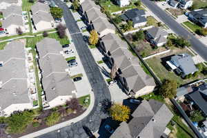 Aerial view of property and surrounding area with nearby suburban area