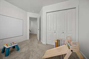 Playroom with baseboards and light carpet
