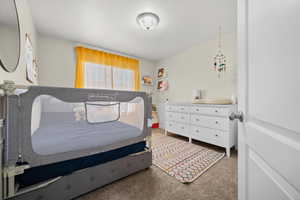 Bedroom featuring light colored carpet